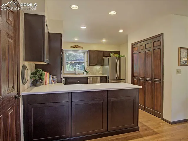 a kitchen with stainless steel appliances a sink and a refrigerator