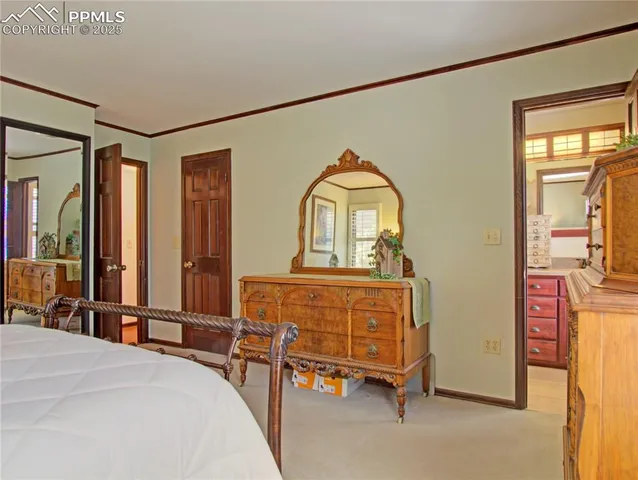 a bedroom with a bed a dresser and mirror