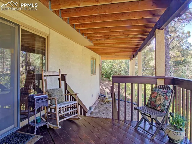 a view of balcony with wooden floor and outdoor seating