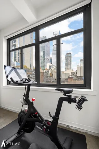 a living room with furniture a flat screen tv and a large window