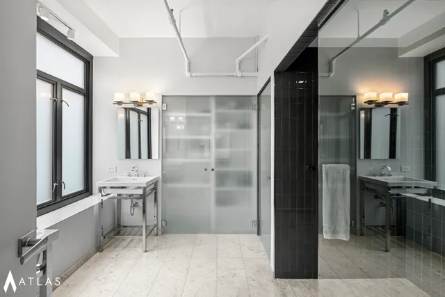 a spacious bedroom with a large bed and a large window