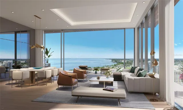 a living room with lots of furniture and a large window