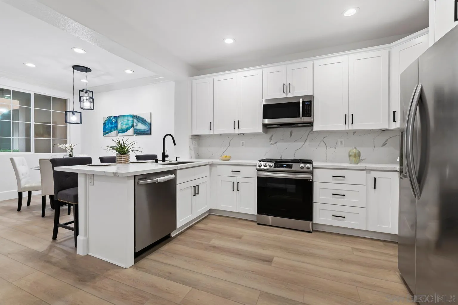 13002 Requlo Place San Diego, CA 92130 - Photo 3 of 17 a kitchen with a white stove top oven and refrigerator