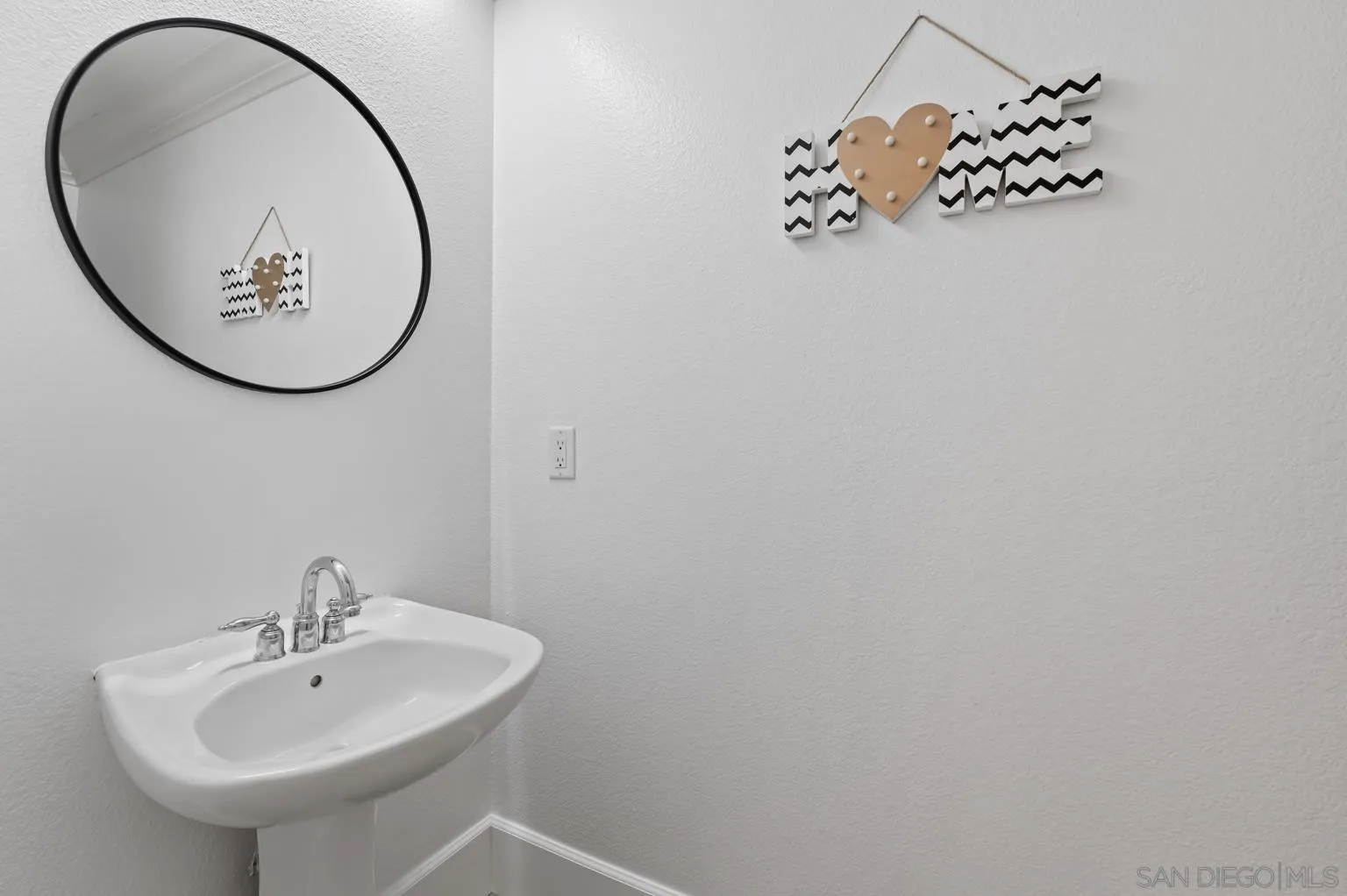 13002 Requlo Place San Diego, CA 92130 - Photo 5 of 17 a bathroom with a sink and a mirror