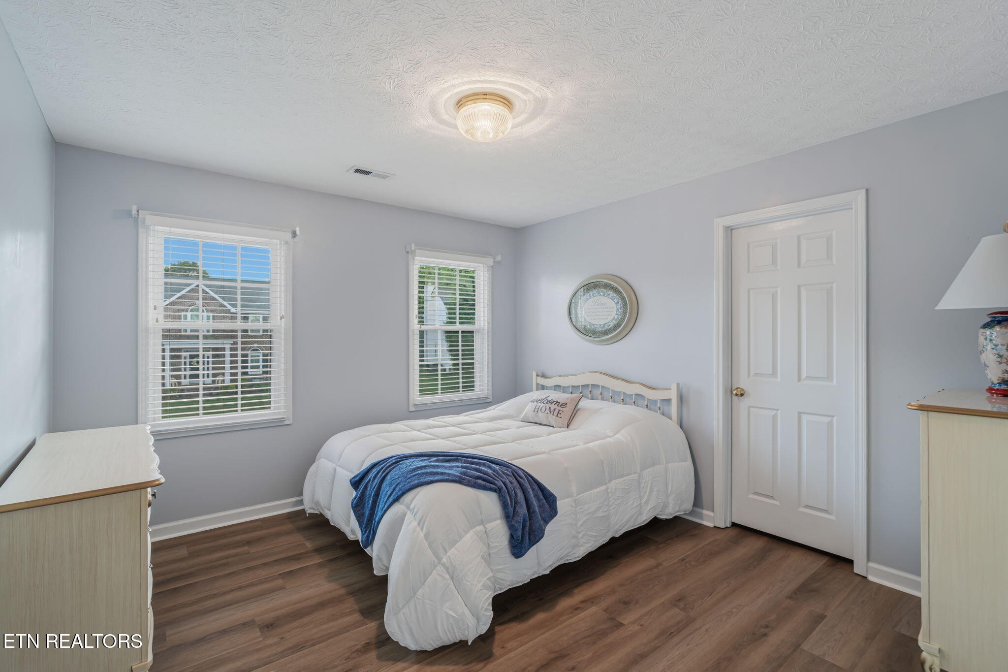 7030 Westerly Winds Road Knoxville, TN 37931 - Photo 27 of 40 a bedroom with a bed and wooden floor