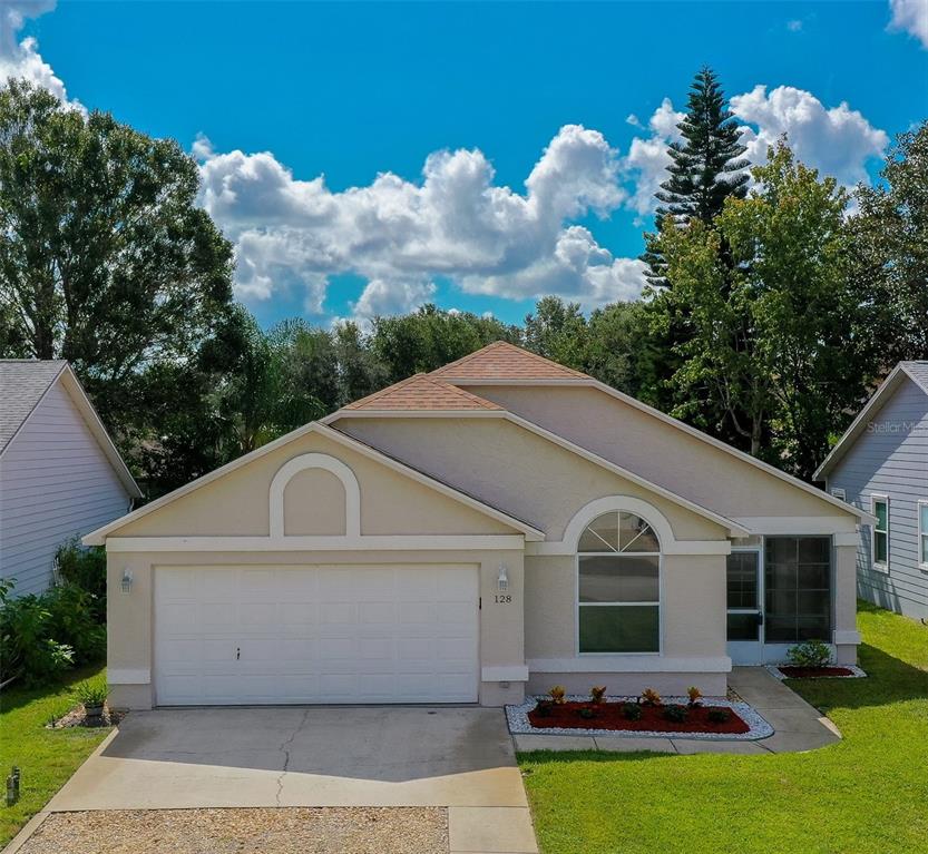 128 Crooked Pine Road Port Orange, FL 32128 - Photo 1 of 46 a front view of house with yard and outdoor seating