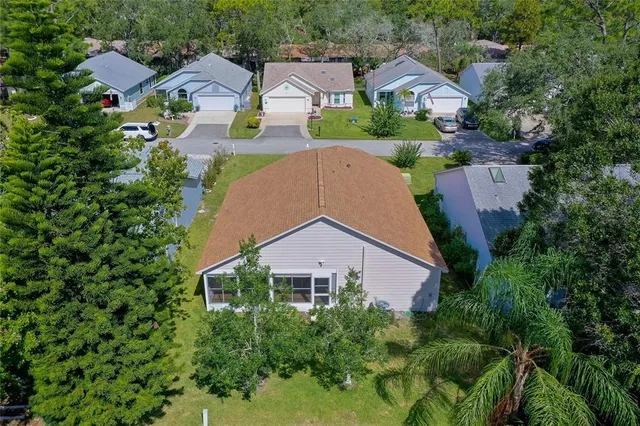 an aerial view of a house with garden space and a street view
