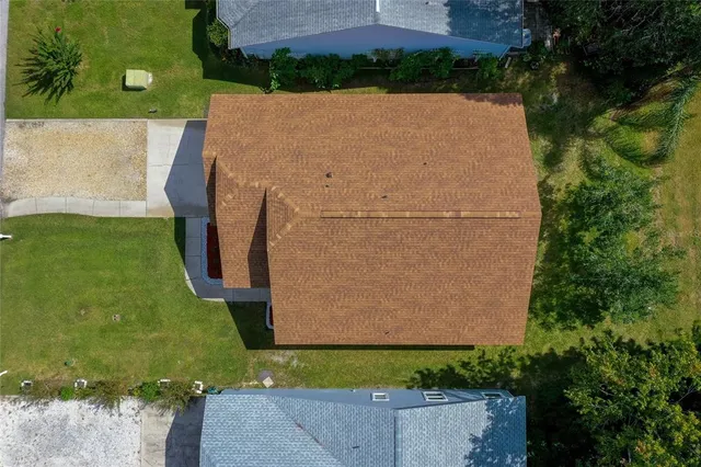 an aerial view of a house with a yard