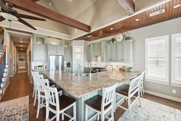 a kitchen with sink and view of living room