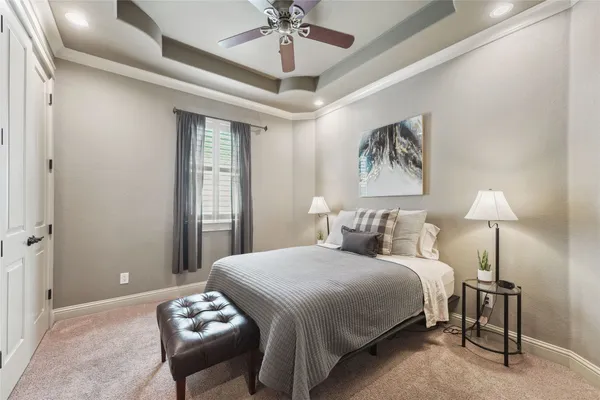 a spacious bedroom with a bed and window