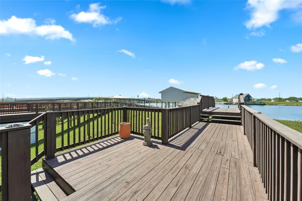 a balcony with wooden floor and city view