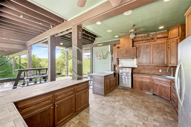 a kitchen with sink refrigerator and window