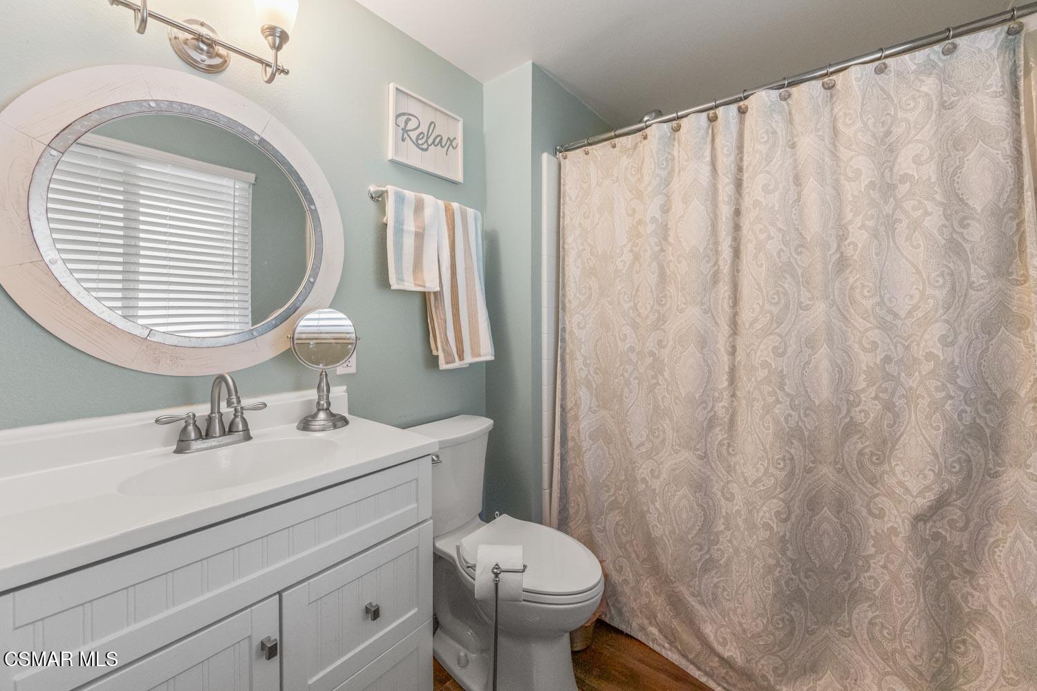 2413 Lita Place Simi Valley, CA 93063 - Photo 14 of 17 a bathroom with a toilet sink and mirror