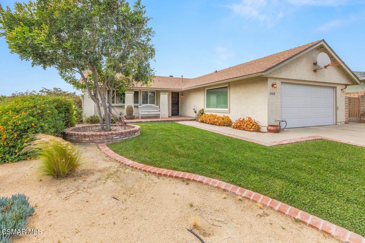 2413 Lita Place Simi Valley, CA 93063 - Photo 2 of 17 a front view of a house with a yard and trees