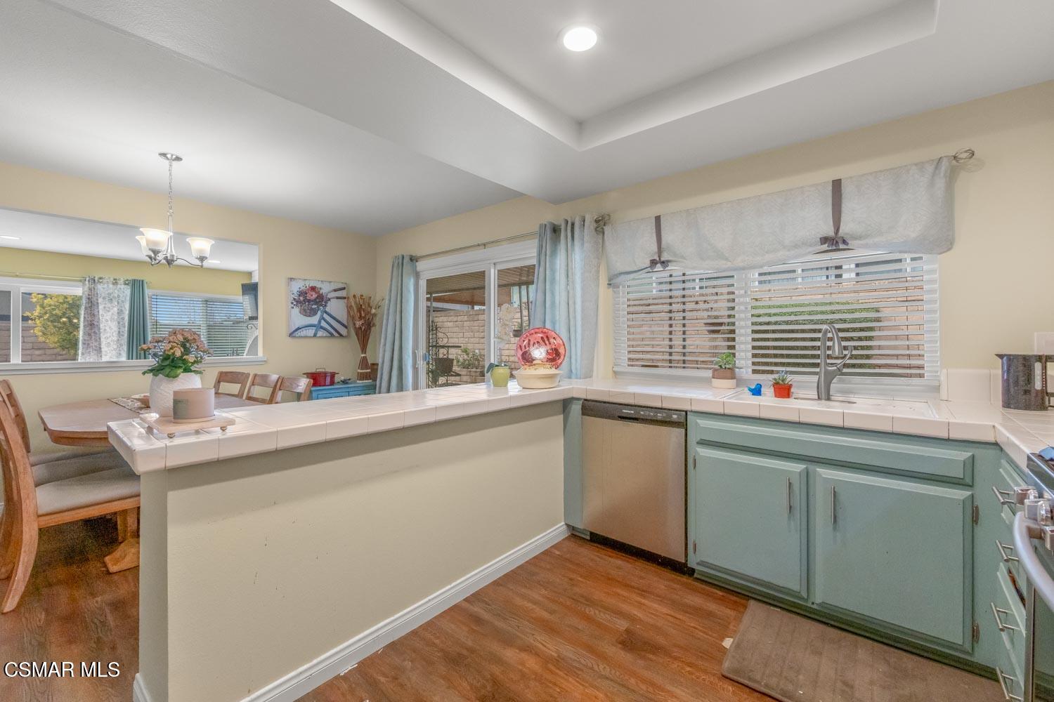 2413 Lita Place Simi Valley, CA 93063 - Photo 5 of 17 a kitchen with sink cabinets and wooden floor