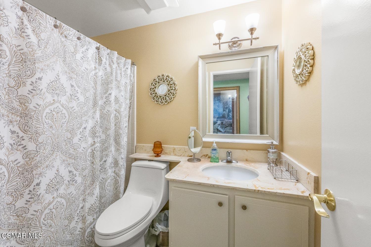 2413 Lita Place Simi Valley, CA 93063 - Photo 10 of 17 a bathroom with a toilet sink and mirror