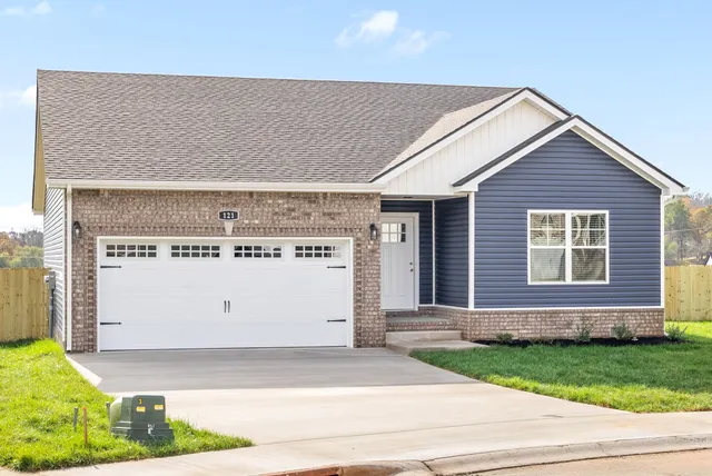 a view of a house with a yard and garage