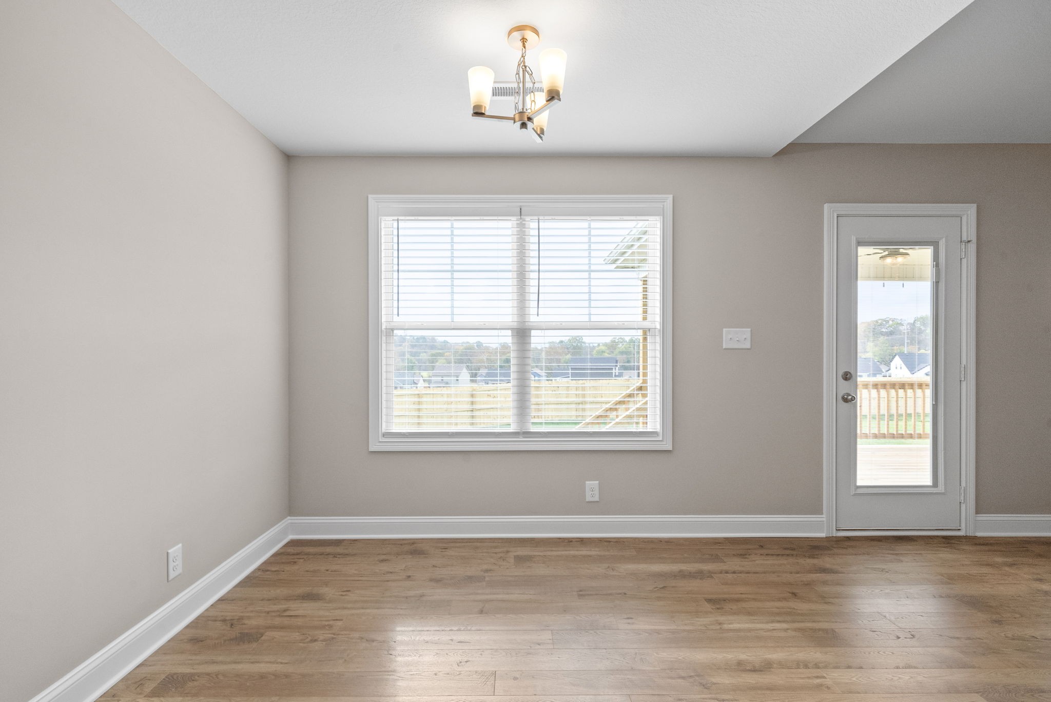 30 Echo Ridge Oak Grove, KY 42262 - Photo 9 of 43 a view of an empty room with wooden floor and a window