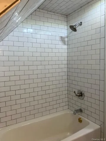 a bathroom with a shower and a sink