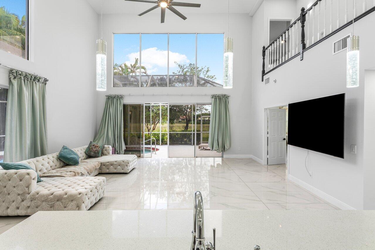 7748 Travelers Tree Drive Boca Raton, FL 33433 - Photo 11 of 35 a living room with fireplace furniture and a flat screen tv