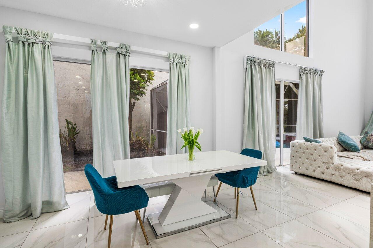 7748 Travelers Tree Drive Boca Raton, FL 33433 - Photo 12 of 35 a living room with furniture and a potted plant