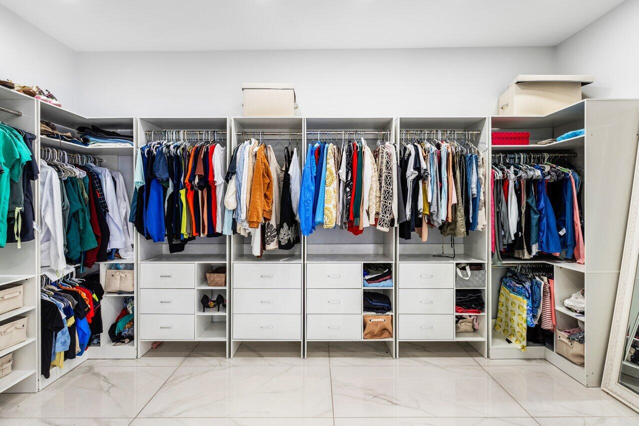7748 Travelers Tree Drive Boca Raton, FL 33433 - Photo 17 of 35 a view of walk in closet with clothes and shoes