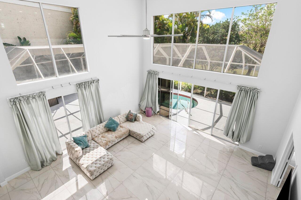 7748 Travelers Tree Drive Boca Raton, FL 33433 - Photo 23 of 35 a view of a living room with a floor to ceiling window and wooden floor