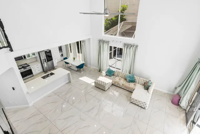 a bedroom with bed and a large window