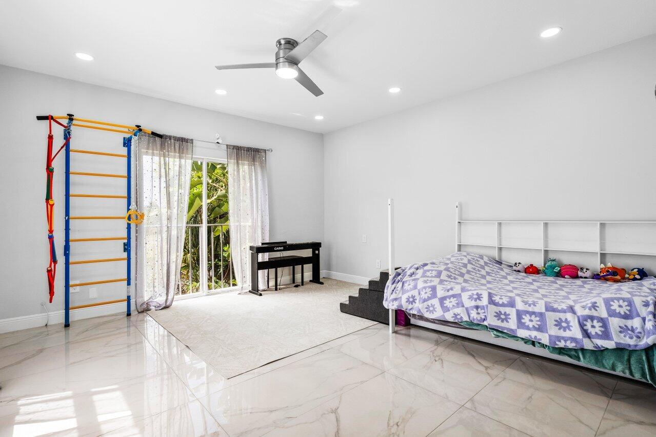 7748 Travelers Tree Drive Boca Raton, FL 33433 - Photo 25 of 35 a bedroom with bed and a large window