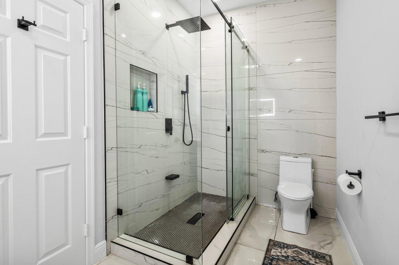 7748 Travelers Tree Drive Boca Raton, FL 33433 - Photo 27 of 35 a bathroom with a shower and a toilet