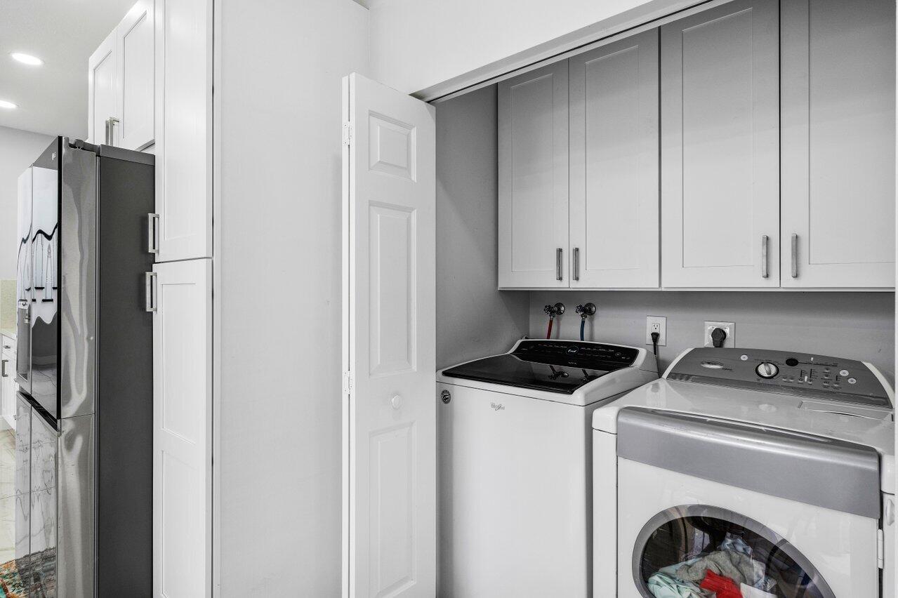 7748 Travelers Tree Drive Boca Raton, FL 33433 - Photo 28 of 35 a utility room with sink dryer and washer