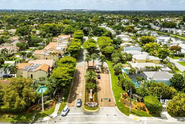 an aerial view of a house with a garden and lake view