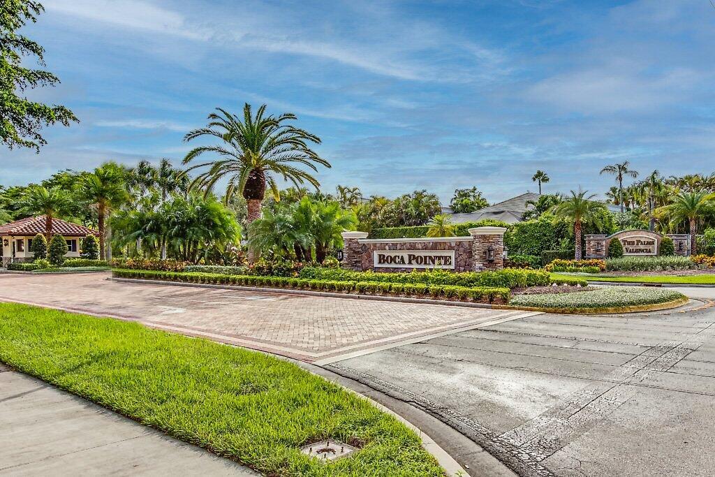 7748 Travelers Tree Drive Boca Raton, FL 33433 - Photo 33 of 35 a view of a swimming pool with a yard and palm trees