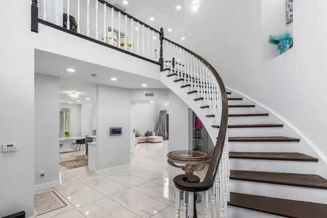 a view of entryway and hall with wooden floor