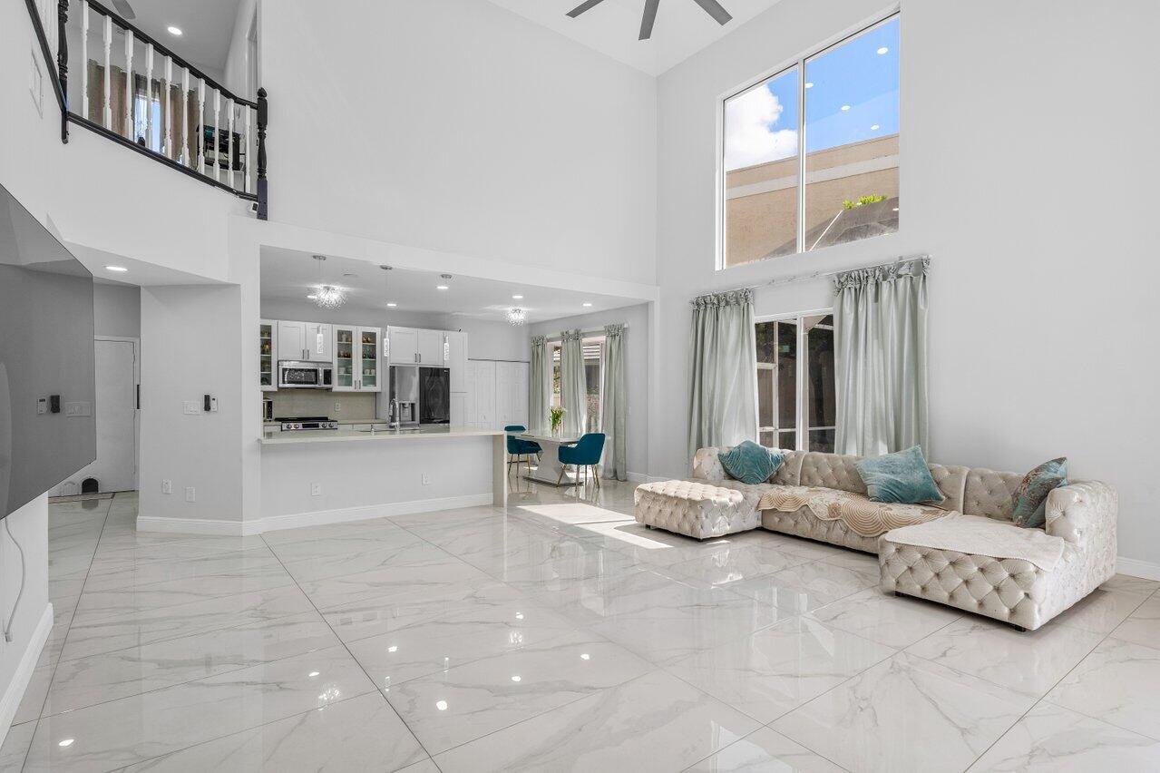 7748 Travelers Tree Drive Boca Raton, FL 33433 - Photo 6 of 35 a living room with furniture and a table