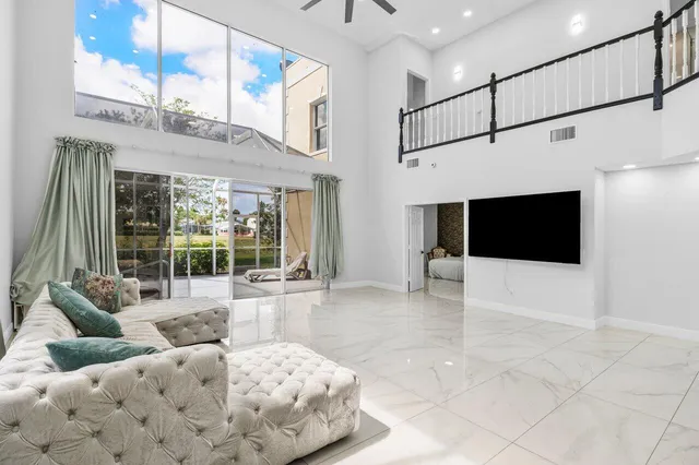 a kitchen with refrigerator and chairs