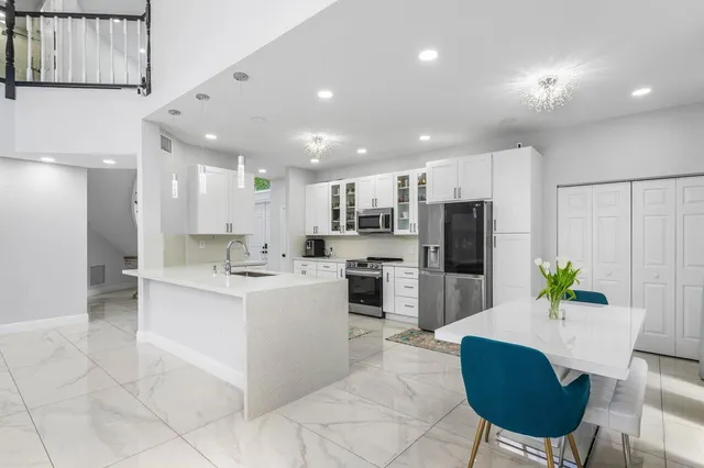 a kitchen with stainless steel appliances granite countertop a stove and a sink