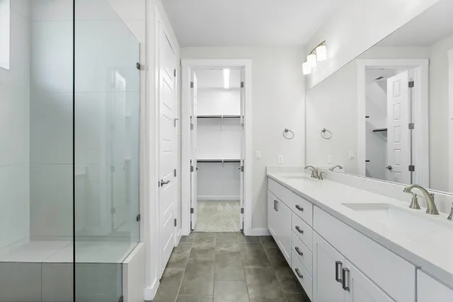 a spacious bathroom with a double vanity sink mirror and double