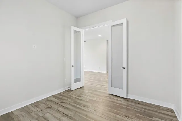 a view of an empty room with wooden floor