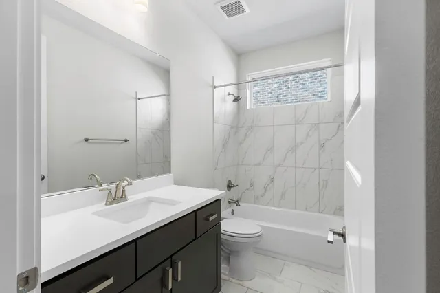 a view of an empty room with a floor to ceiling window next to a yard