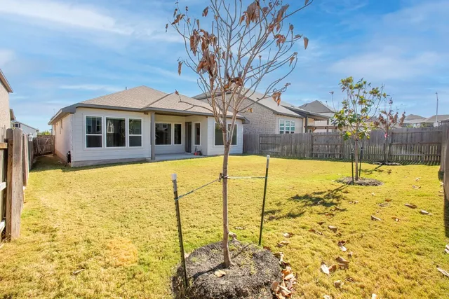 an aerial view of a house with swimming pool and outdoor seating