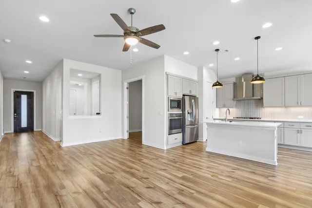 a view of kitchen with wooden floor and a window