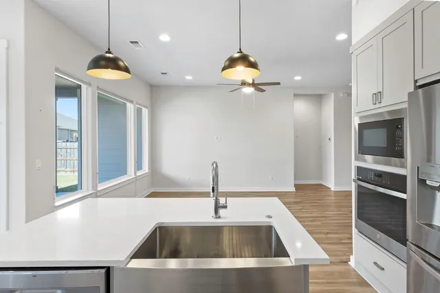 a kitchen with a sink and a refrigerator