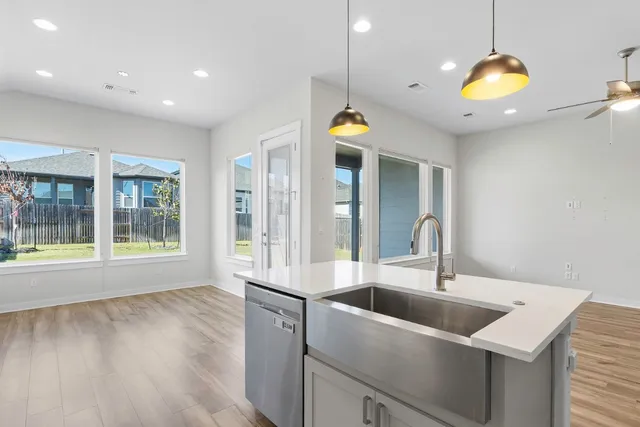 a kitchen with a sink stainless steel appliances and cabinets
