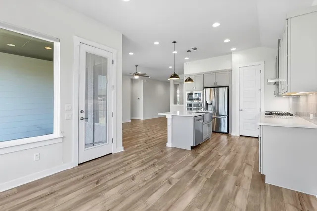 a large kitchen with a lot of counter space and a refrigerator