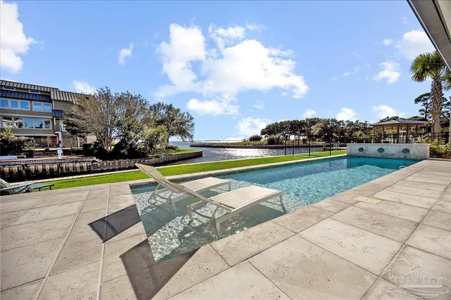 a view of a swimming pool and lounge chairs