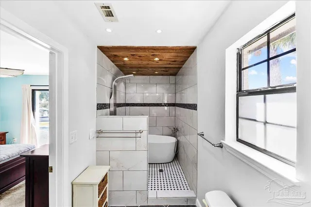 a bathroom with a toilet sink and shower