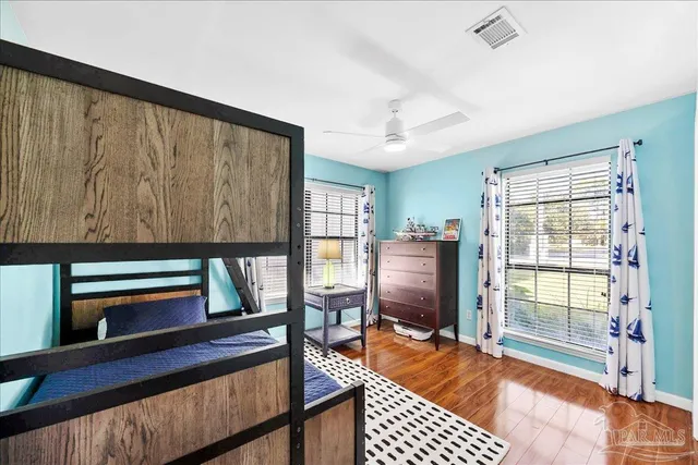a living room with furniture a flat screen tv and a floor to ceiling window
