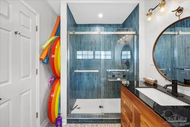 a bathroom with a tub a mirror and a sink