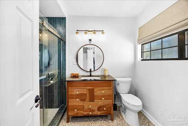 a bathroom with a toilet a sink and a mirror